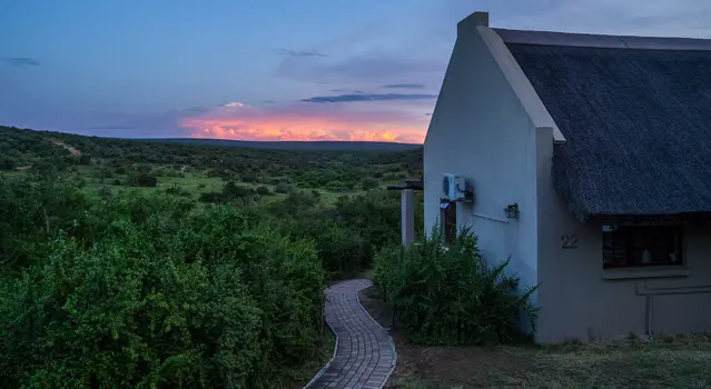 Addo Main Rest Camp on of the smaller chalets with overcast sky and sunset