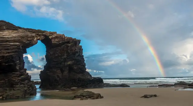Cathedral Beach with rainbow after a brief shower in winter