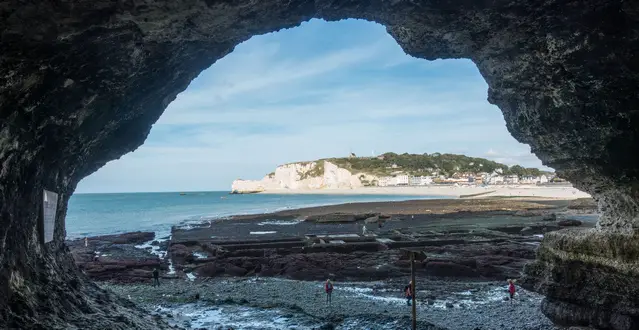 Walk through the tunnel to the arches of Etretat at low tide