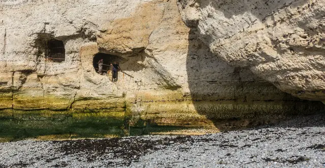 Access to the hidden beaches of Etretat through a tunnel during low tide