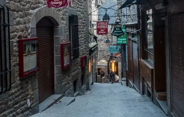 Narrow alleys are empty at Mont Saint Michel during the evening