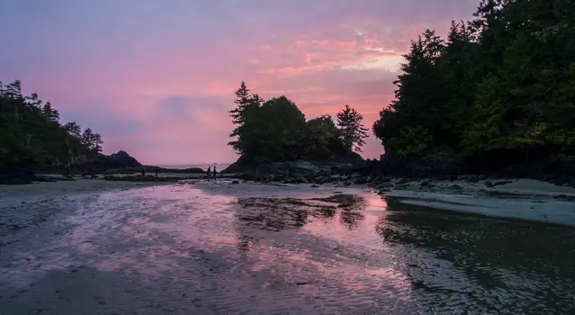 Tofino; MacKenzie Beach during winter after heavy rainfall with purple coloured sunset