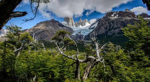 Fitz Roy called smoking mountain with clouds around and blue sky