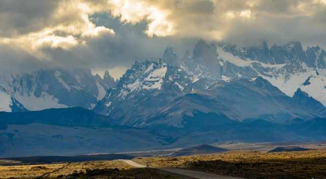 Fitz Roy and Cerro Torre covered in clouds view fron the gravel road