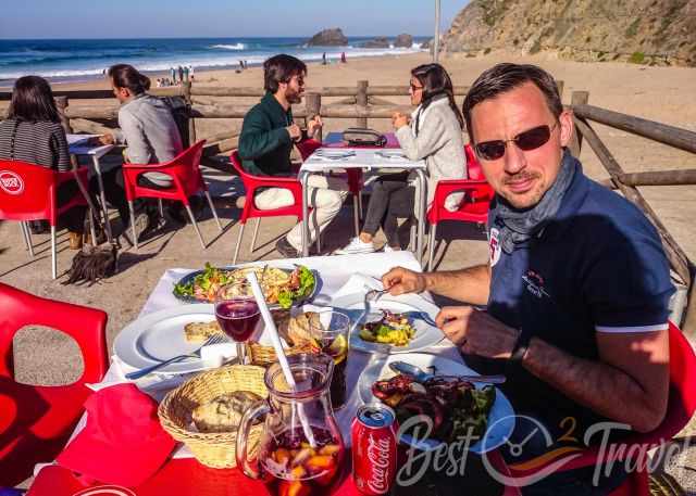 The outdoor seating from the restaurant and Adraga beach in the back