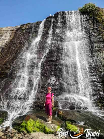 A woman barefoot in front of the Alamere Falls