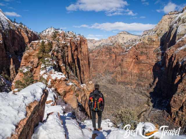 A hiker on the top of Angels Landing enjoying the view to the canyon.