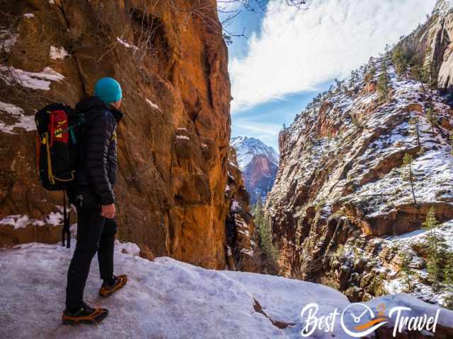 A hiker enjoying the stunning landscape in Zion in winter.