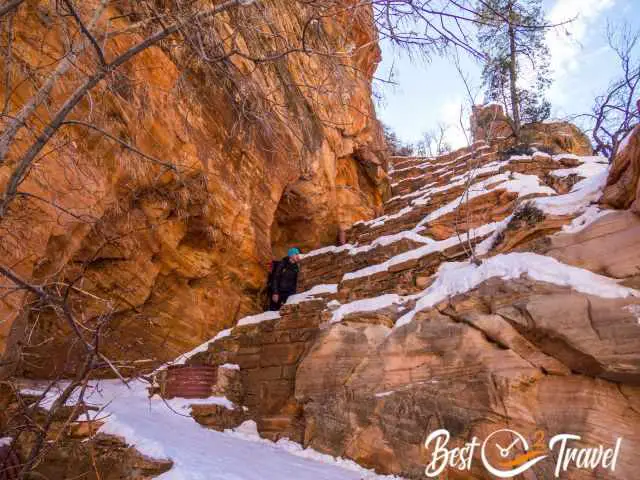 A hiker zigzagging on the West Rim Trail.