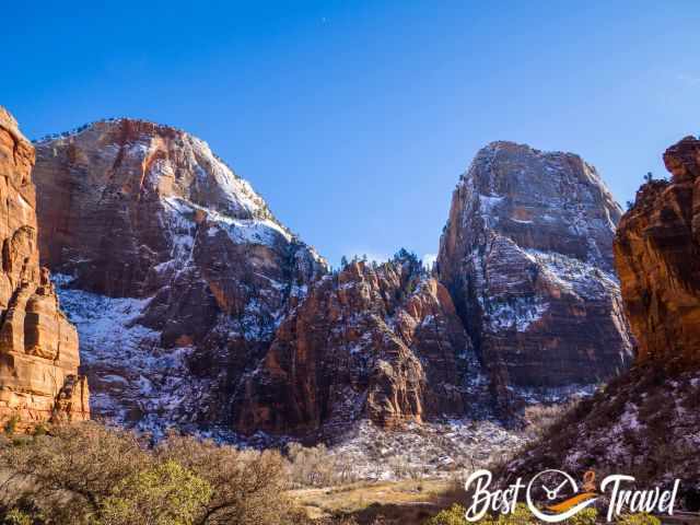 View from a small car park in Zion up to the orange sandstone mountains.