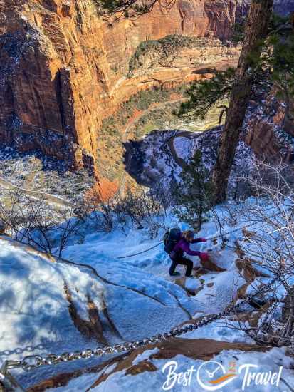 A female hiker along the chain section to the summit.