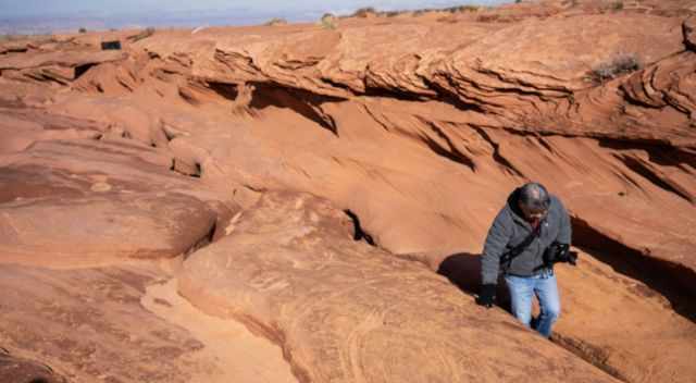 Lower Antelope entrance - man walking into it in a warm jacket and gloves