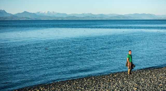 Spring on a beach on Malcolm Island with snow covered mountains in the back