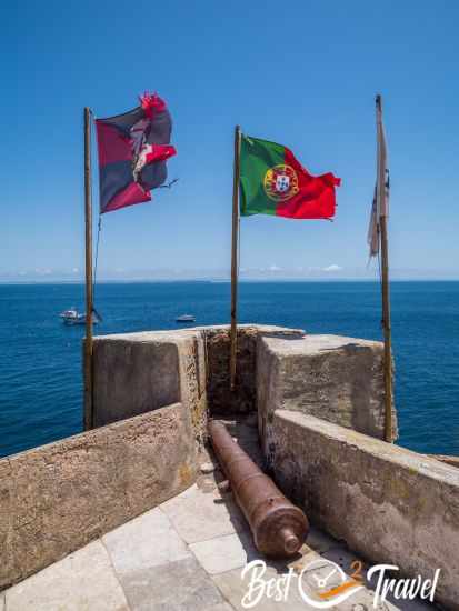Flags and a cannon on top of the fortress