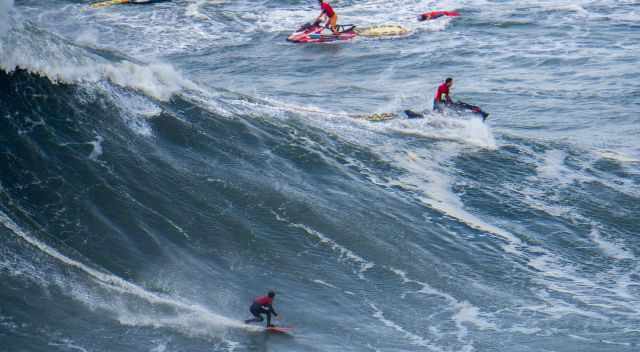 One surfer but three jet skies for safety reason