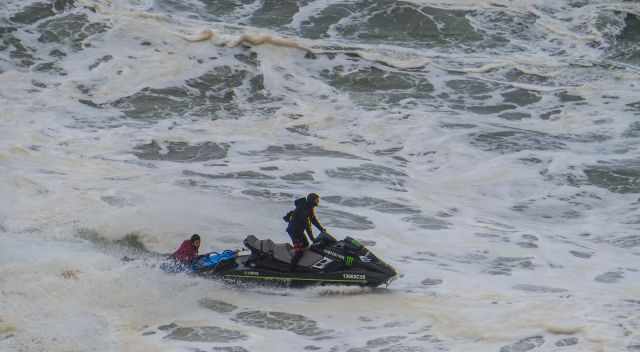 A surfer picked up from the jet ski