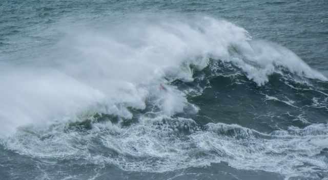 A surfer gets hit by a big wave.