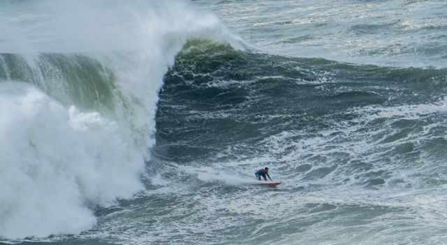 A Brazilian surfer on a big wave in Nazare