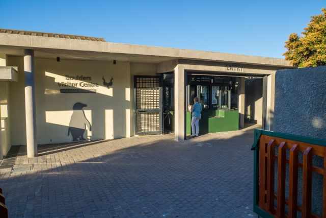 Entrance of the Boulders Beach penguins visitor area with the SANParks sign and the ticket counter where visitors purchase entry to the penguin colony.