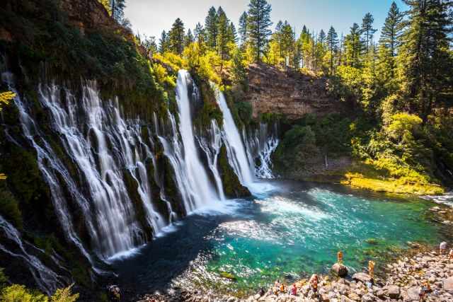 Burney Falls in summer with visitors at the pool of the falls