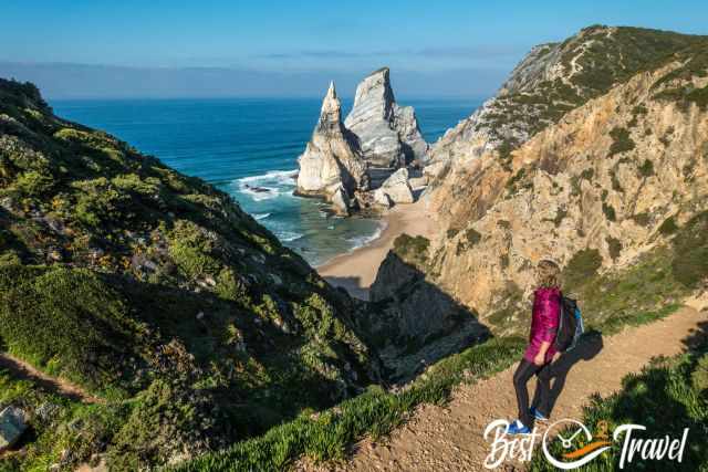 A female hiker with a spectacular view to Praia da Ursa