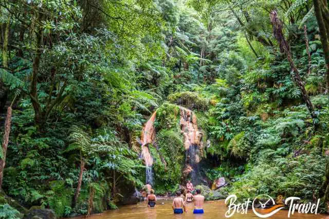 Visitors in the most popular pool in front of the waterfall.