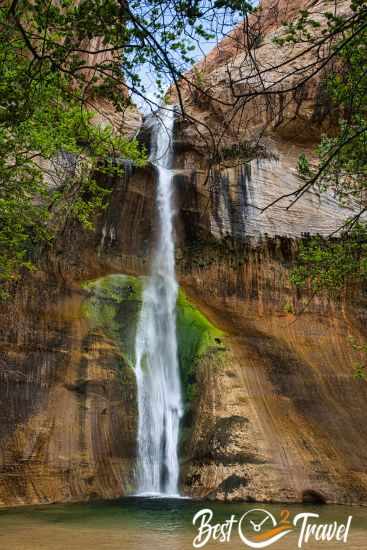 The Lower Calf Creek Falls with yellow and green moss on either side