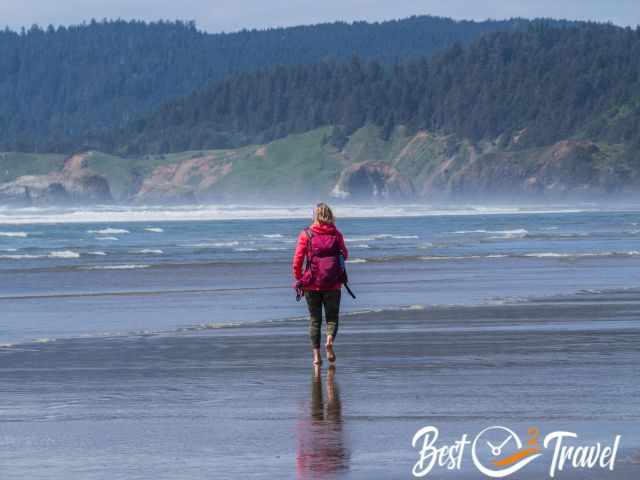 A woman walking on the endless beach