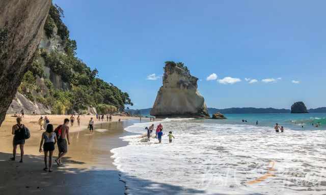 Cathedral Cove Beach and Te Hoho Rock at low tide with visitors