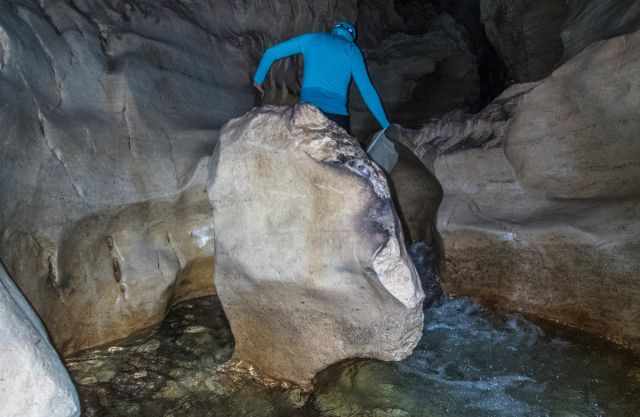 Climbing through the stream inside the cave