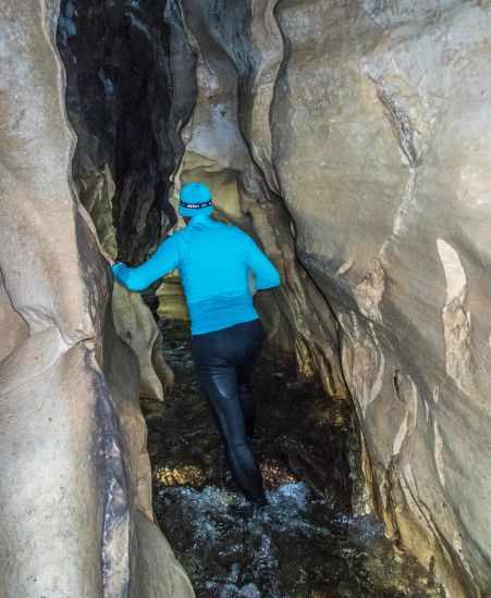 A man walking through the cave