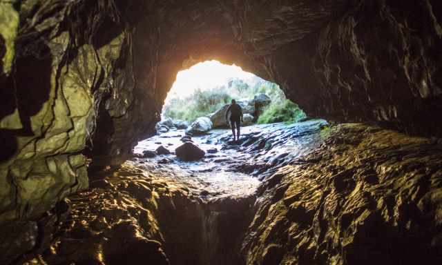 A man walking out of the cave