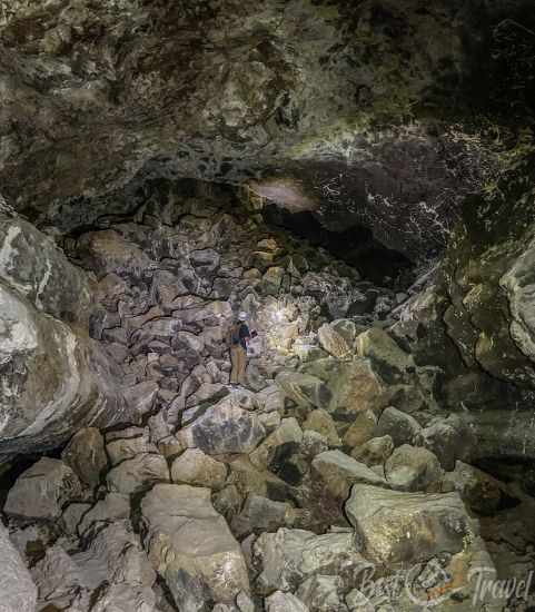 A guide climbing up a rockslide