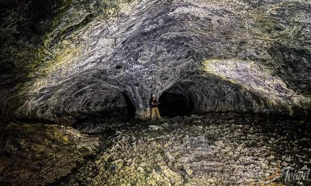 A wide lava tube only 200 years old with a rock formation like a mushroom