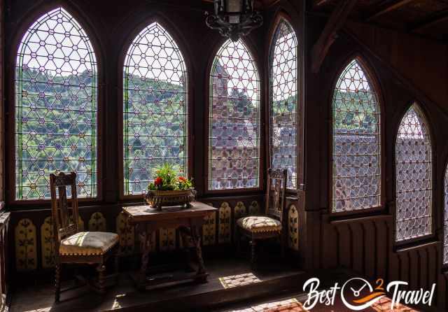 A sitting area with beautifully decorated windows.