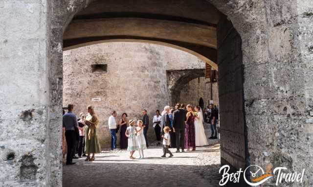 The bride and groom and guests in the castle