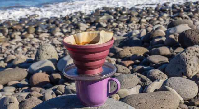 Brewing a fresh coffee everywhere is essential; here at a rocky beach