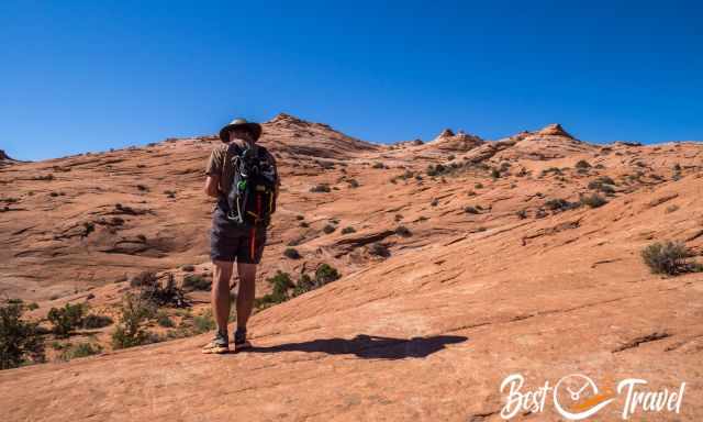 A hiker is looking to his mobile