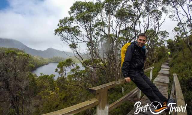 A resting hiker in Cradle with two lakes in the back