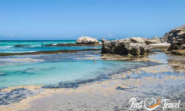 a woman having a bath in a huge tide pool