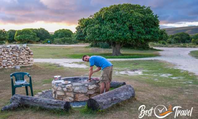 Making a BBQ in the provided fire pit in front of the cottage