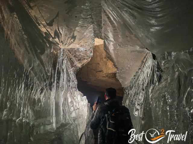 Visitors walking though a thick ice shield.