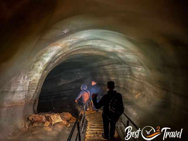 Visitors walking on the staircase through the ice tunnel.