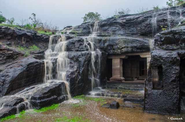 Ellora Caves with a splashing waterfall at the entrance