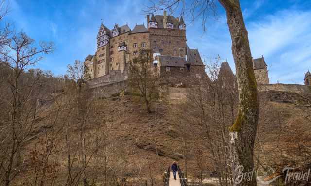 Bridge crossing Eltz stream and Eltz Castle in the background