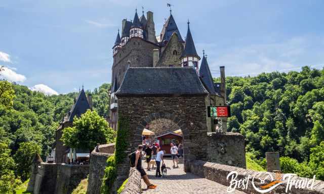 Front view from the bridge to Eltz Castle with a couple of day trippers.