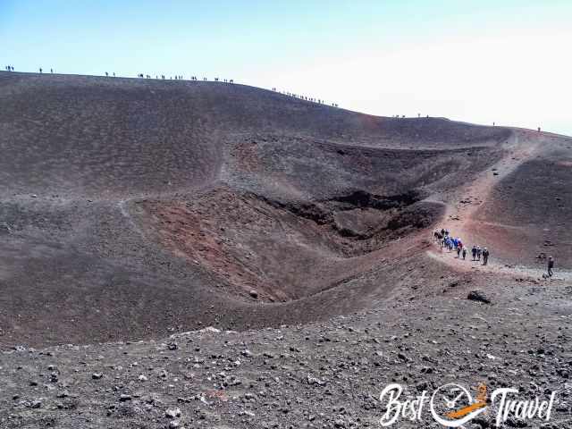 Many visitors are on the rim of one of the craters.