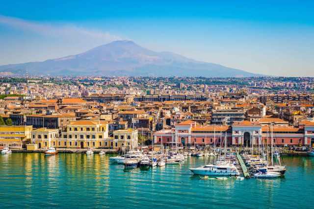 The harbour of Catania and Etna in the back.