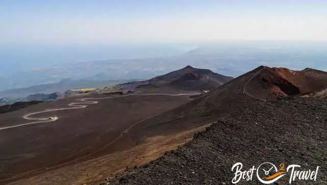 View from the end of the dirt road down to craters and jeeps