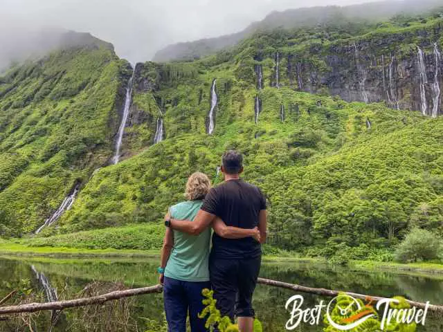 A couple standing in front of Poco Ribeira do Ferreiro